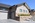 custom home view of garage door and stairway and front siding