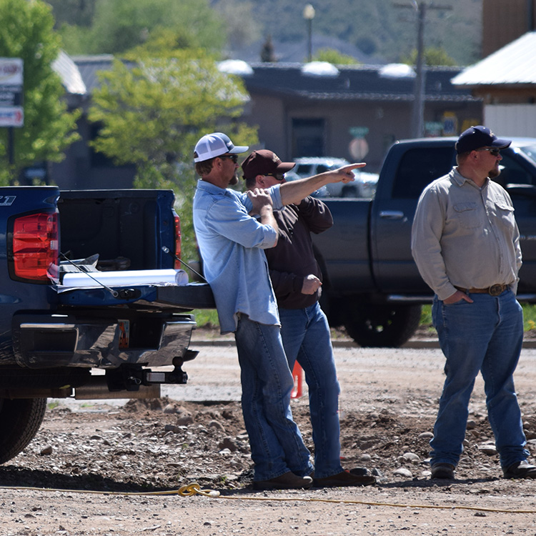 Project manager discussing project progress with owners of future commercial project in Northern Utah