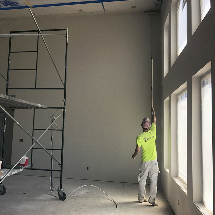 Center Point employee painting wall for a custom home in northern Utah
