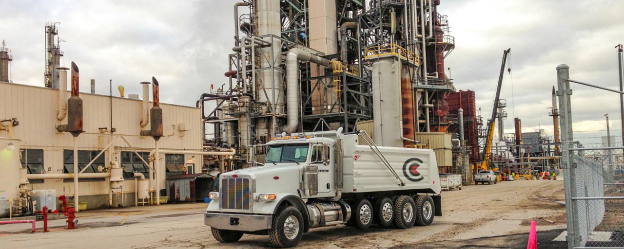 Center Point dump truck parked in an industrial park oil refinery