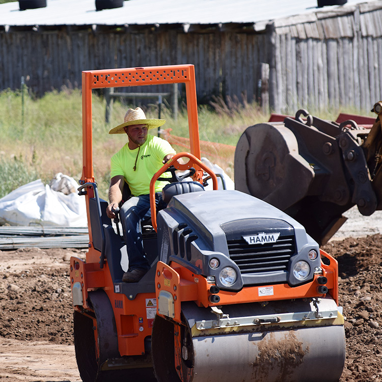 Rolling compactor being driven by Center Point Construction employee in Morgan, Utah