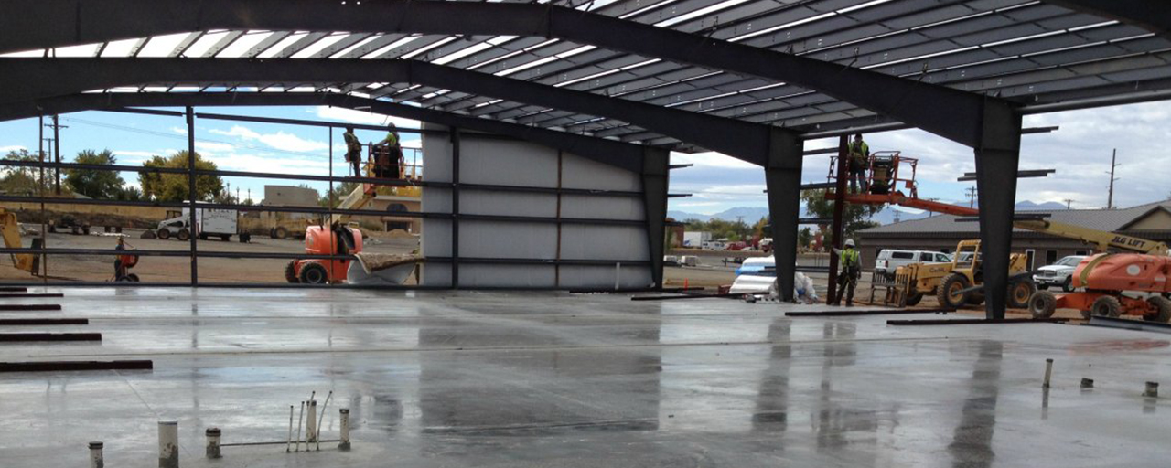 concrete pad and steel frame building under construction