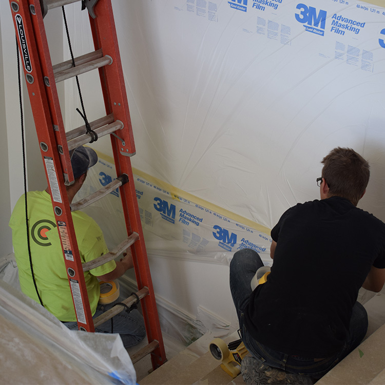 Center Point employees preparing for painting a custom home