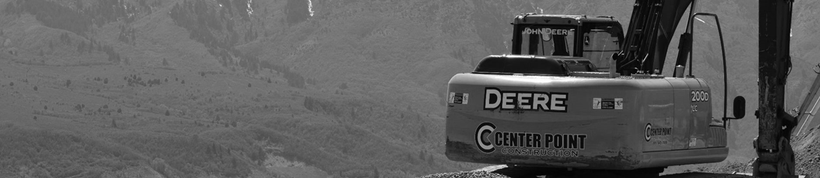 back of trackhoe with Center Point Construction logo with mountains in the background