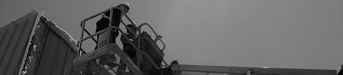 electric boom lift holding two Center Point Construction workers